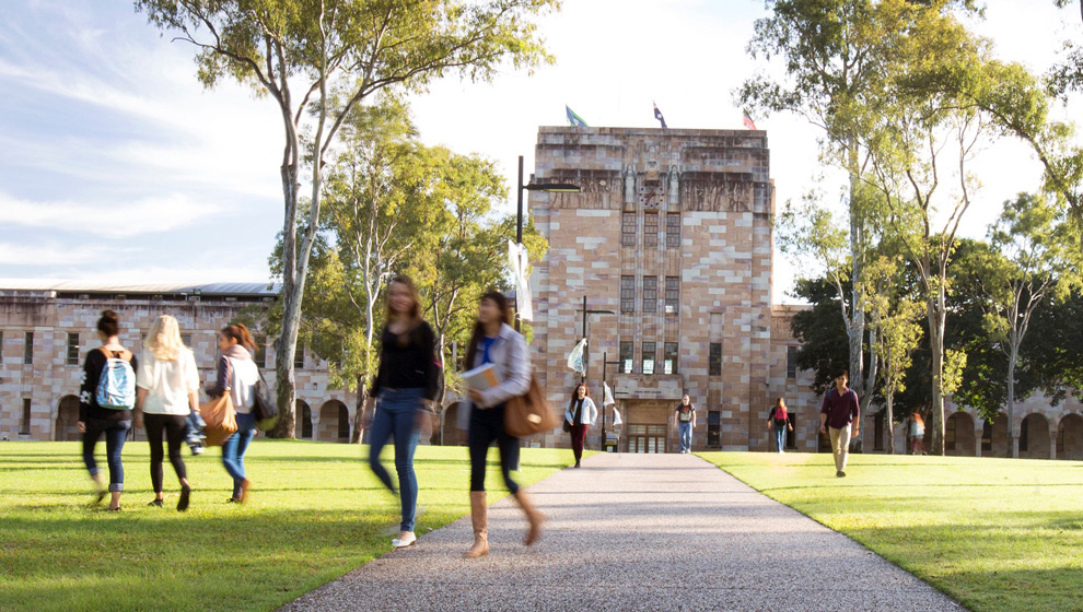 Imagem da fachada da Universidade de Queensland, na Austrália, frequentada por alunos.